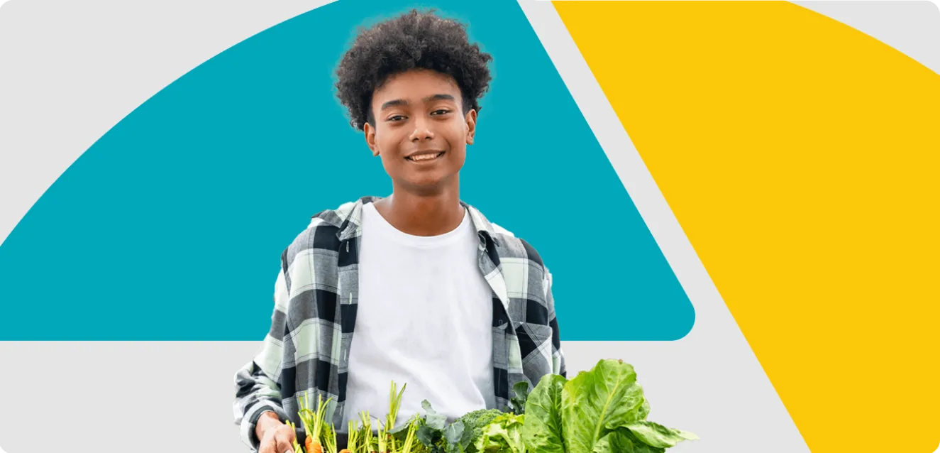 Image of a boy holding a tray of fresh produce