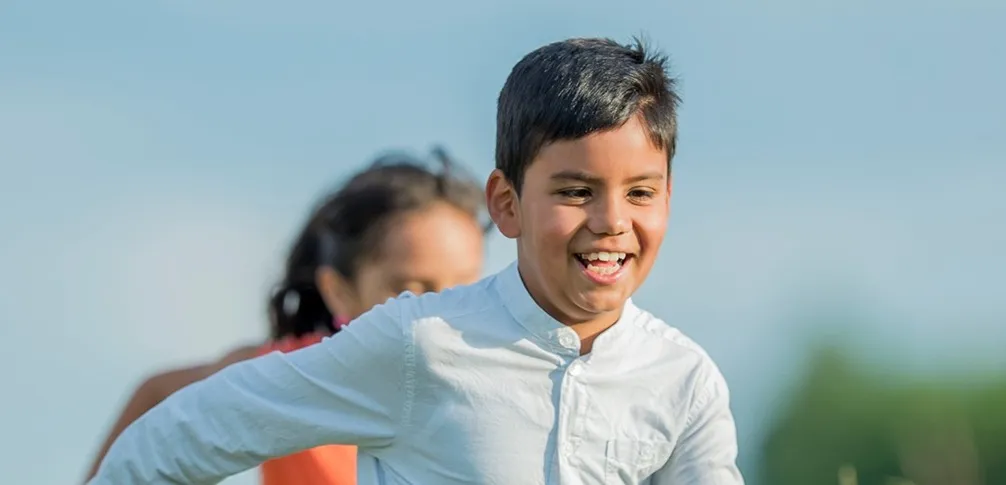 A picture of a child running and smiling
